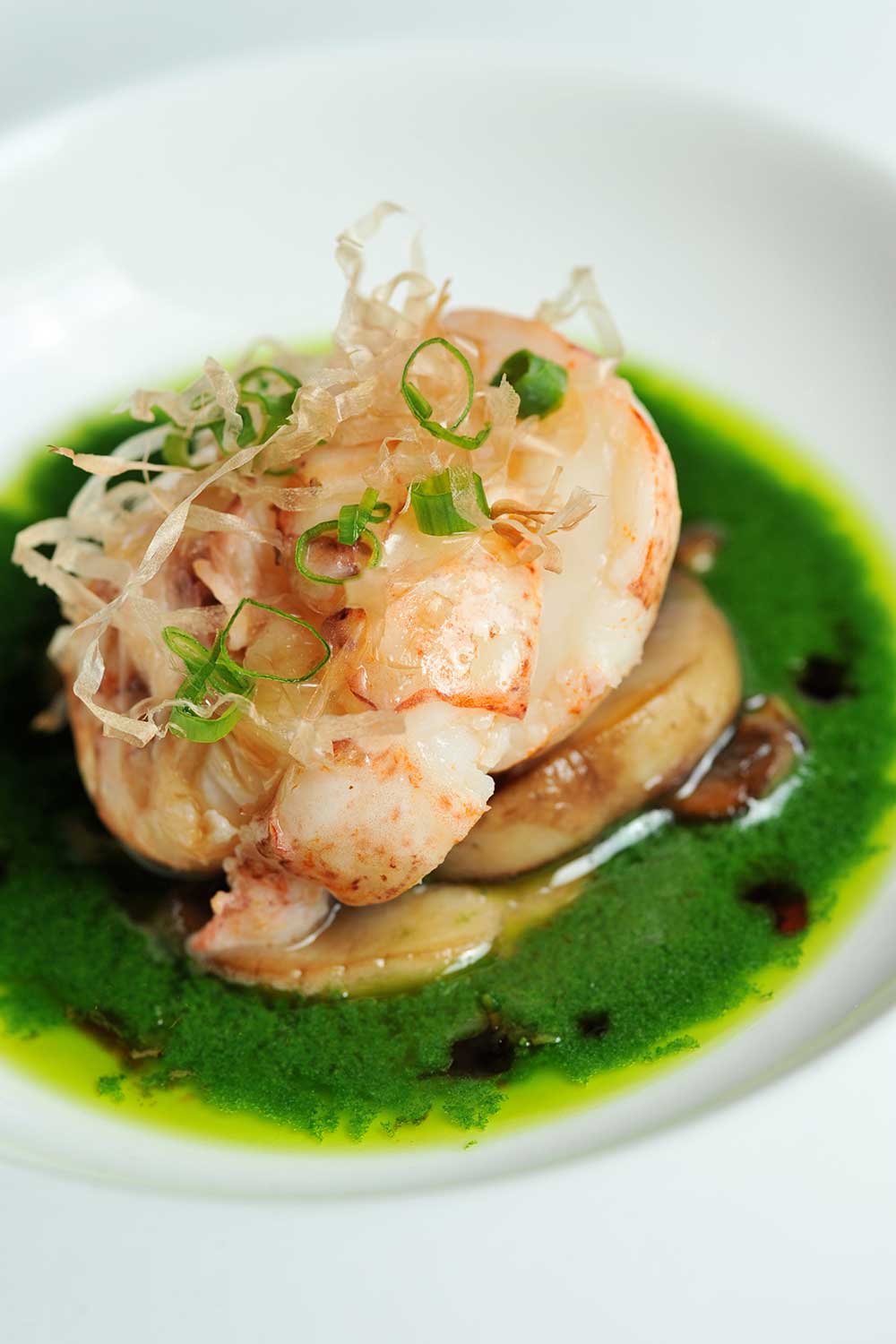 HRC_2 Shrimp dish placed nicely on some green colored sauce in white plate