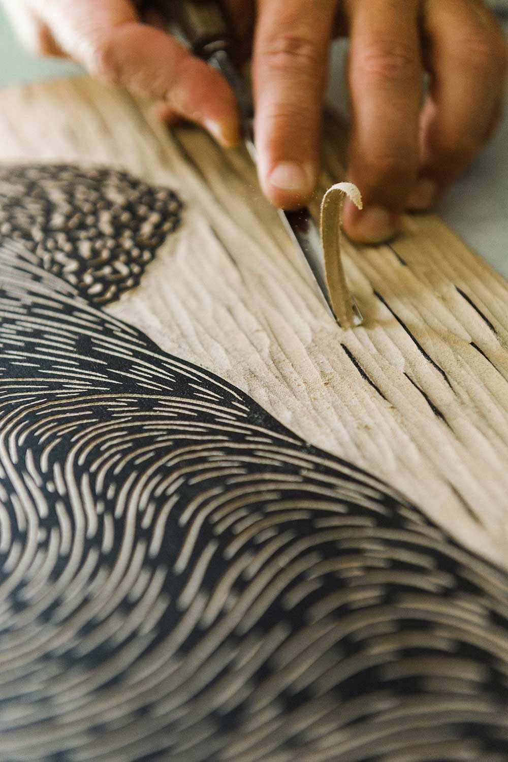 Close up of Steven Kean's hand make a woodcut
