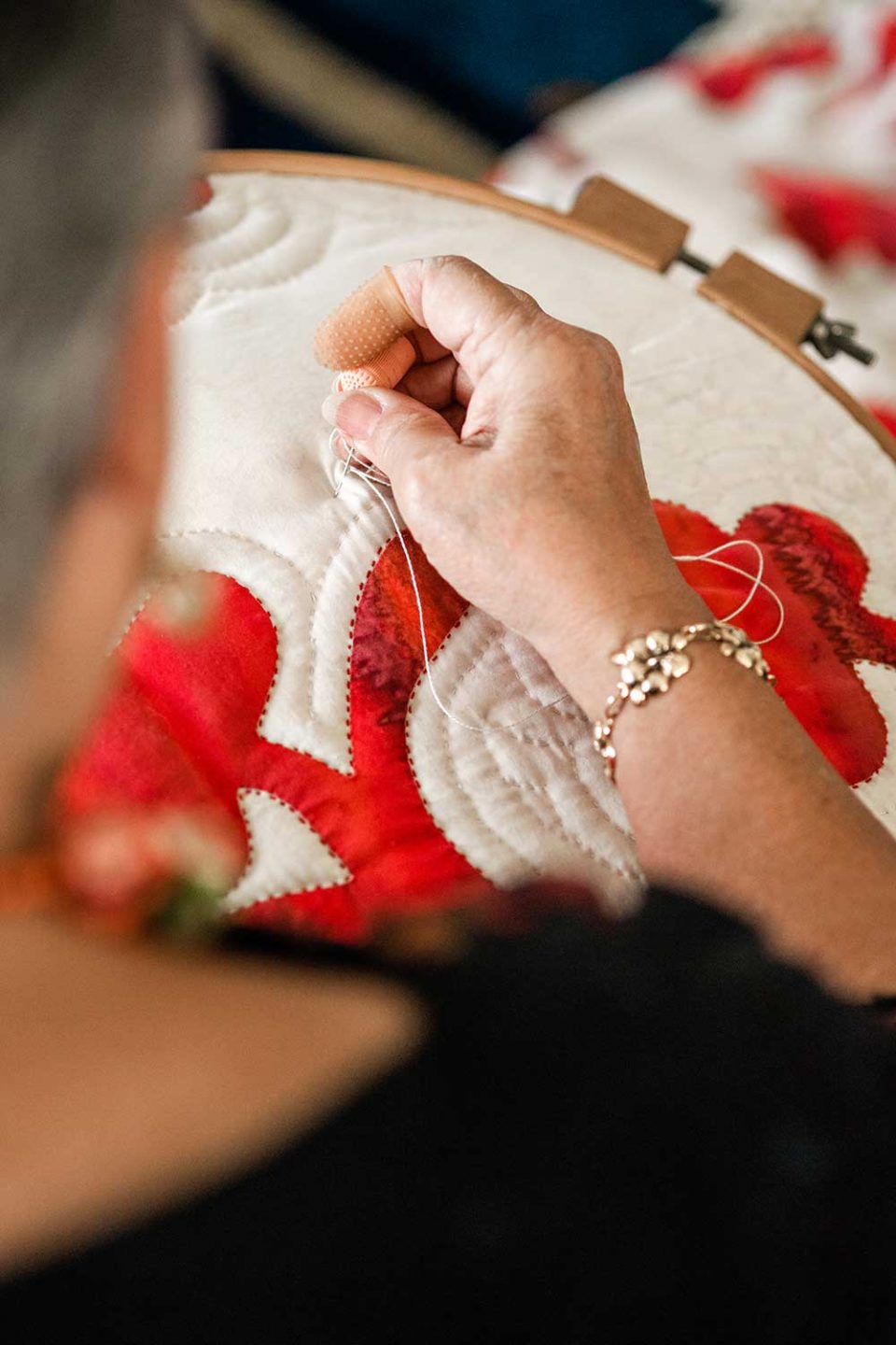Patricia Lei Murray threading through her quilt.