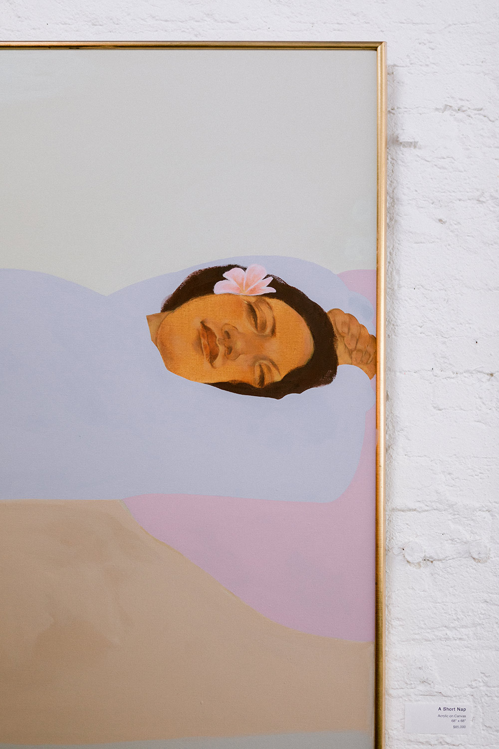 A painting of a woman taking a nap with a plumeria flower in her hair.